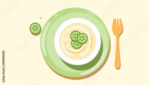 Plate of creamy soup with cucumber slices and wooden fork  