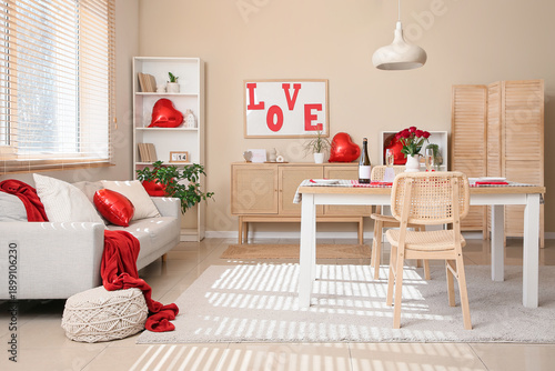 Interior of festive living room with served table and decorations for Valentine's Day celebration