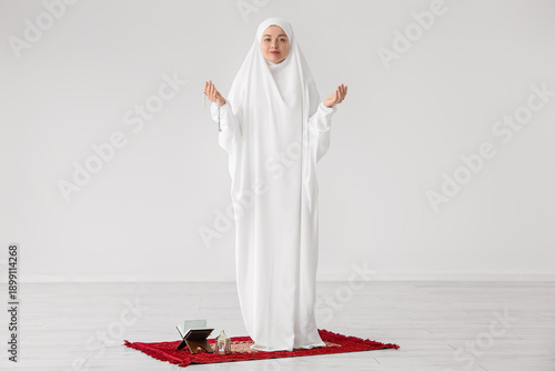 Young Muslim woman with tas...