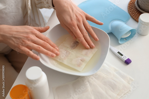 Young woman dipping mustard...