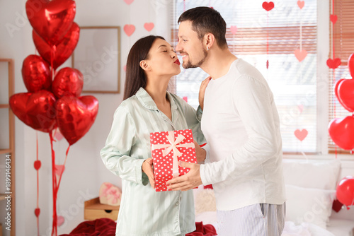 Young Asian woman with gift...