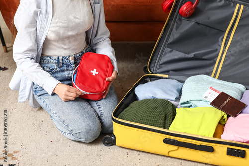 Young woman with suitcase p...