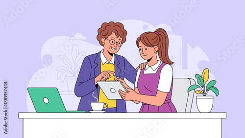 Two women, an older mentor and a younger colleague, collaborating and learning together in a modern office environment, looking at a digital tablet.