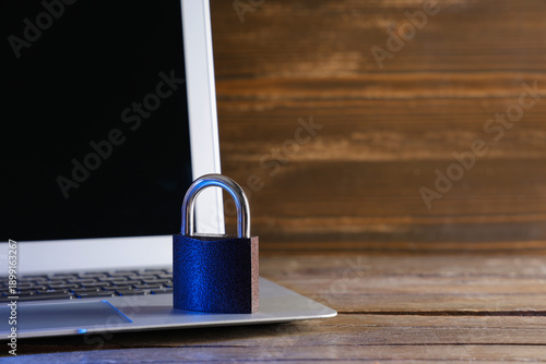 Laptop with padlock on wood...