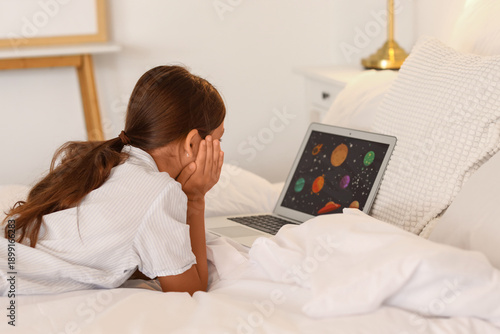 Little girl watching cartoo...