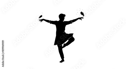 Silhouette of a male dancer performing a traditional Indian dance with birds in his hands, showcasing cultural art and movement.