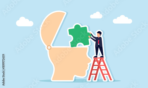 Businessman using ladder to place puzzle into head mannequin illustrating critical thinking and business problem solving