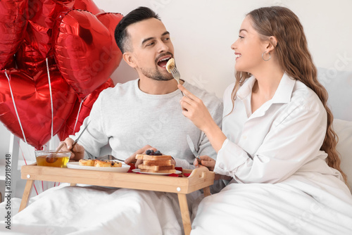 Young couple having breakfa...