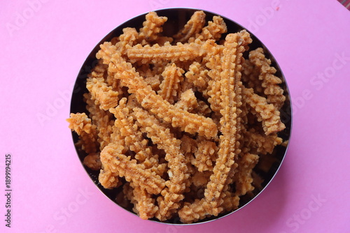 Chakli, Murukku, Traditional Indian Diwali snack in a dish, crispy spiral shaped deep fried savoury snack made with rice flour and spices