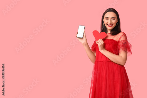 Happy young woman with mobi...