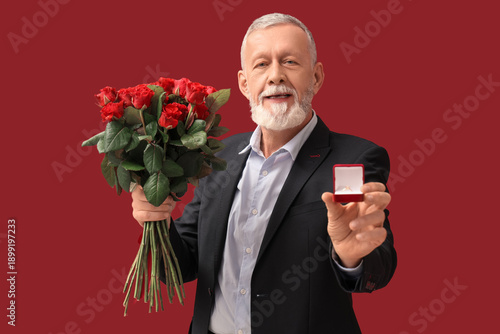 Mature man holding bouquet ...