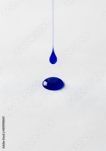Blue Liquid Droplet on White Surface.