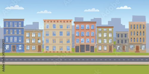 A colorful row of townhouses stands against a bright blue sky with fluffy