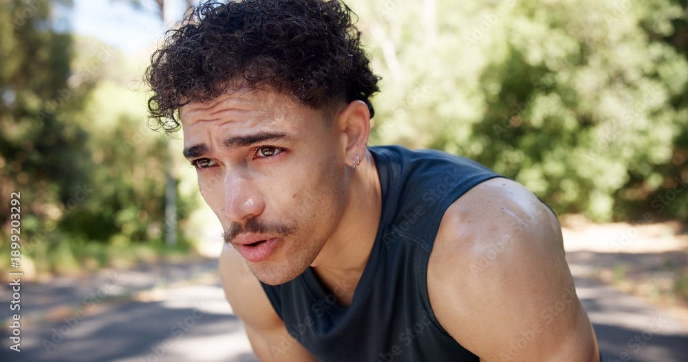 Fototapeta premium Exhausted, man and outdoor with breathing from cardio workout, exercise challenge and sports fatigue. Active person, sweat and tired in road with training break, fitness and recovery for wellness.