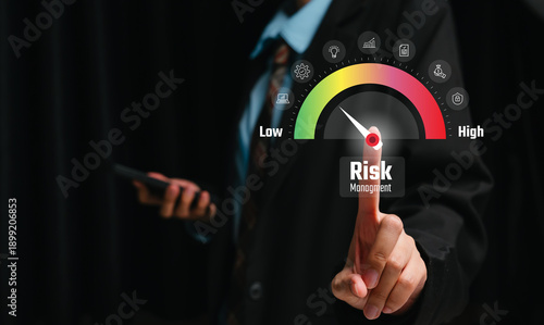 Risk management concept. Businessman touching risk level indicator gauge interface, assessment analysis, compliance control, corporate decision making, strategic planning.