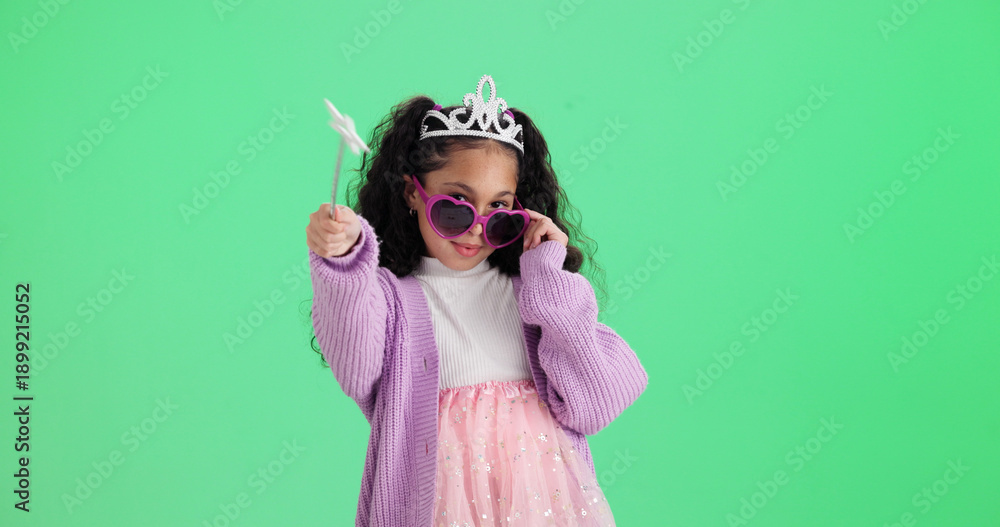 Obraz premium Girl, portrait or wand with costume in studio for halloween party or dress up on a green background. Child, kid or princess with fairy tale outfit, fashion or style for magic or cosplay on space
