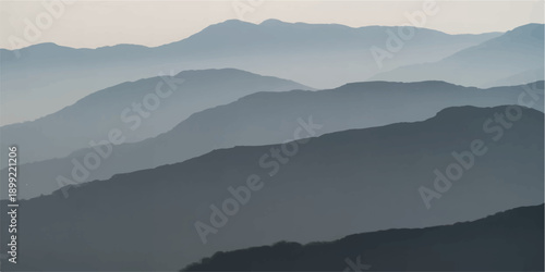 A serene morning mist blankets the blue mountain range as the sun rises over a foggy forest valley under a glowing sunset sky