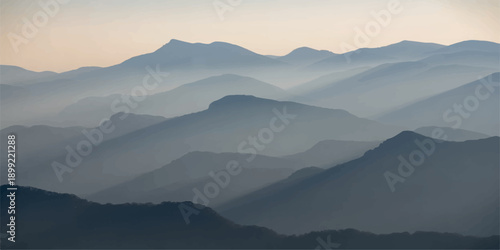 A serene morning mist blankets the blue mountain range at sunrise, revealing a misty forest valley under a glowing sky as the sun casts light over the fog-covered hills and silhouetted peaks