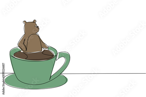 Single line drawing of adorable brown bear for nature concept features cute animal soaking in a coffee cup. Colorful grizzly celebrates an international cafe day theme with the forest beast