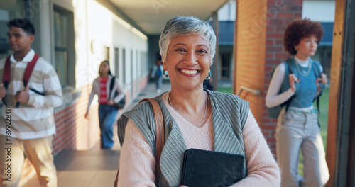 Mature woman, portrait and teacher with confidence in school for higher education or learning. Female person, happy instructor or academic professor with smile for tutoring service or help on campus