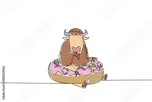 One line drawing of adorable bison features brave wild animal sitting inside glazed donut for pastry food concept. Colorful art is ideal for a coloring page purpose with brown prairie mammal creature