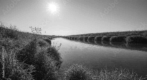 Serene river flowing through lush vegetation under a bright sun in a peaceful landscape view