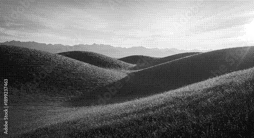 Rolling hills and mountains in a serene landscape viewed from a high vantage point on a sunny day