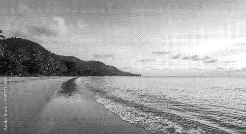 Serene beach scene with gentle waves and majestic mountains viewed from the shoreline