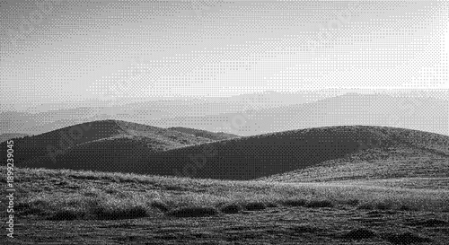 Rolling hills and mountains stretching into the distance, captured from a high vantage point in a serene landscape scene