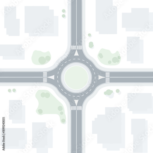Aerial view of a modern roundabout intersection with roads, crosswalks, and buildings