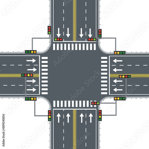 Top view of a busy four-way intersection with traffic lights and crosswalks