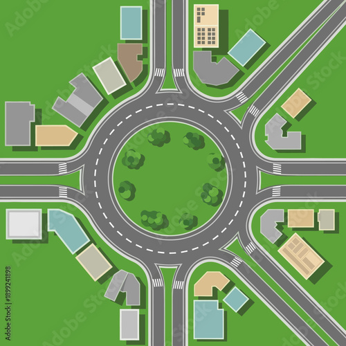 Top View of a Roundabout Intersection with Buildings and Greenery