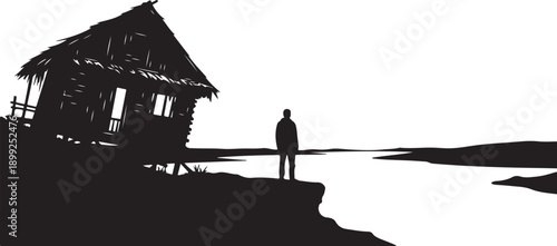 Silhouette of a man standing by a wooden hut