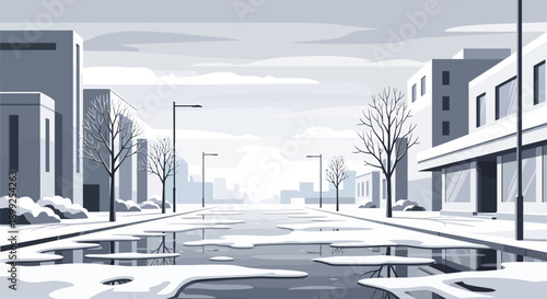 Snowy city street with buildings trees and puddles on a cloudy day