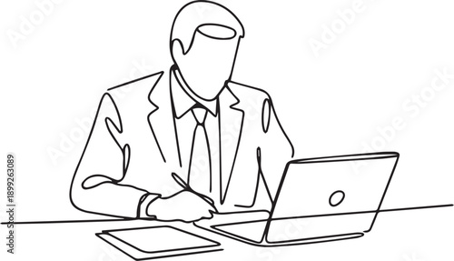 Businessman working on laptop with stylus and notepad on a desk in a professional setting from a straightforward viewpoint