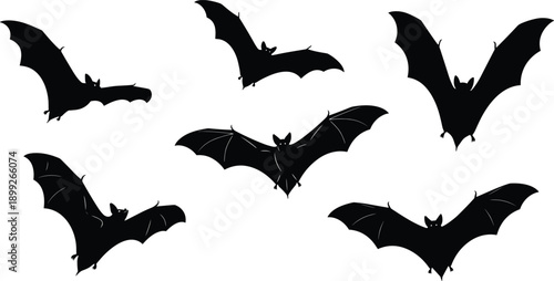 Multiple black bats flying in different directions against a plain background