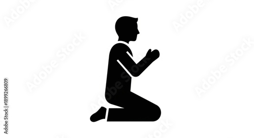 Silhouette of a man praying on his knees.