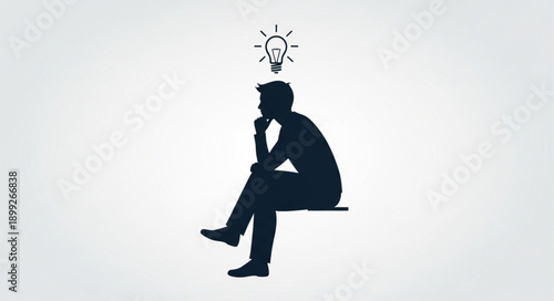 Silhouette of a man sitting and thinking with a lightbulb above his head representing an idea.