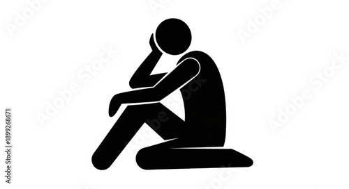 Silhouette of a person sitting with head in hand.