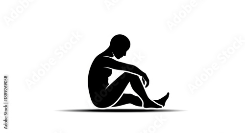 Silhouette of a person sitting alone in despair.