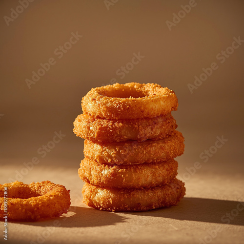 Wallpaper Mural A visually striking food scene featuring crispy onion rings stacked neatly, captured with warm, controlled lighting to reveal crunchy coating details. Subtle shadows add depth without Torontodigital.ca