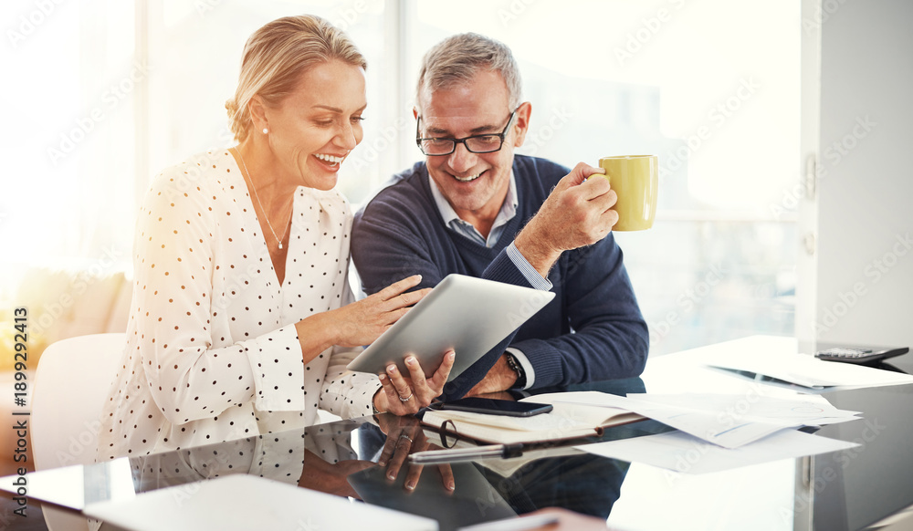 Obraz premium Home, coffee and couple with tablet, happy and financial growth with investment on website or review. Reading, info and planning for retirement with tech, mature man and woman with smile for savings