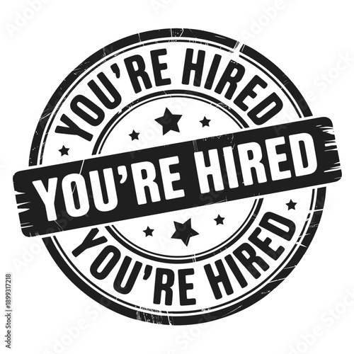 A circular black and white stamp proclaiming you re hired with star accents