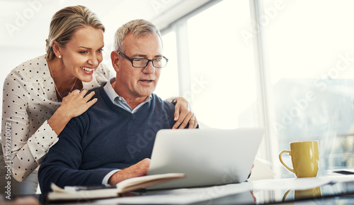 фотографія Hug, laptop and mature couple in home office for budget, finance or investment planning