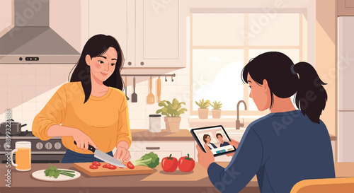 Two women in a kitchen preparing food, one chopping vegetables, the other watching a tablet