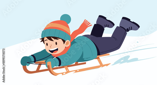 Little boy wearing warm winter clothes and a hat sliding down a snowy slope on a traditional wooden sled with a happy expression.