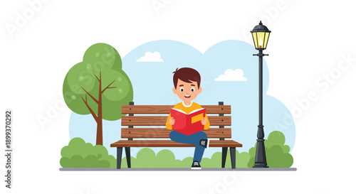 Focused young boy sits on a wooden park bench and reads an interesting red book under a street lamp in the daytime.