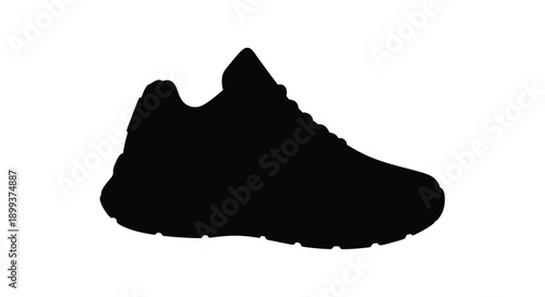 A black sneaker profile dramatically presented as a silhouette