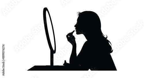 Woman applying makeup while looking in a mirror a striking silhouette