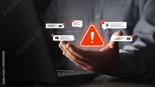 Photos The businessman's hand is touching a virtual alert icon about threats from scams
